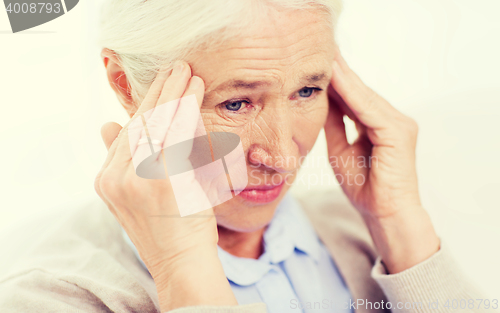 Image of face of senior woman suffering from headache