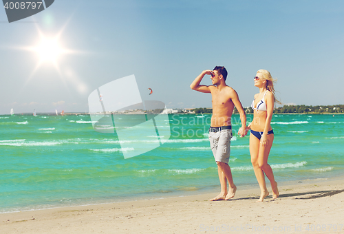 Image of couple walking on the beach