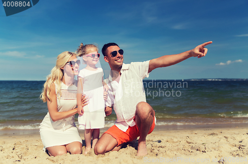 Image of happy family in sunglasses on summer beach