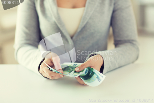 Image of close up of woman hands counting euro money