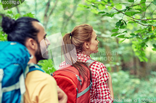 Image of group of smiling friends with backpacks hiking