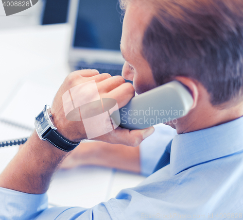 Image of handsome businessman talking on the phone