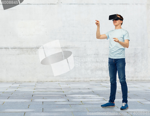 Image of happy man in virtual reality headset or 3d glasses