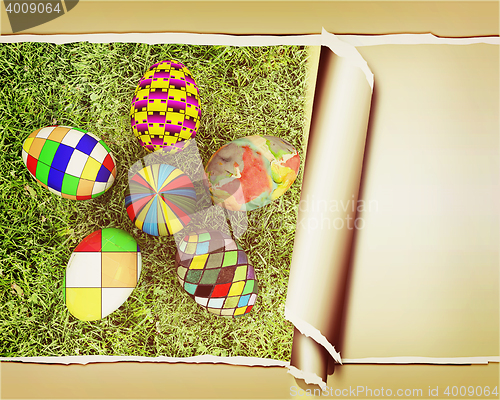 Image of background of flower of easter eggs on the grass, with torn pape