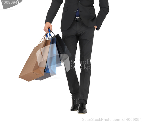 Image of close up of man in suit with shopping bags