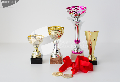 Image of close up of sports golden cups and medals