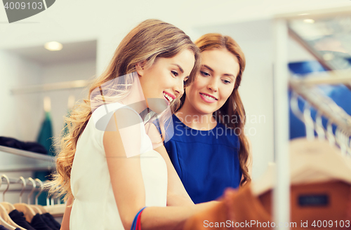 Image of happy women choosing clothes at clothing shop