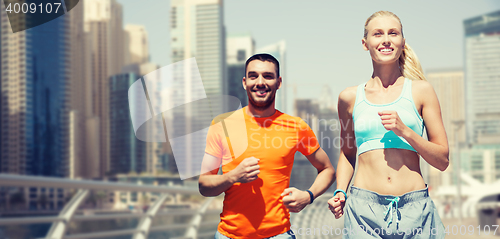 Image of couple running over dubai city street background