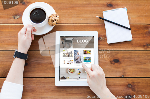 Image of close up of woman with tablet pc on wooden table