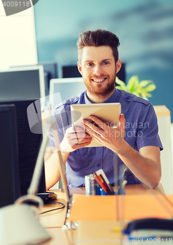 Image of happy creative male office worker with tablet pc