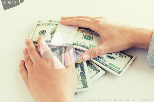 Image of close up of woman hands counting us dollar money