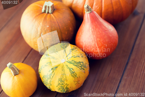 Image of close up of pumpkins on wooden table at home