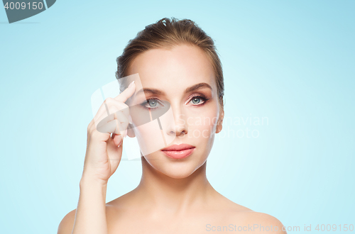 Image of beautiful young woman showing her forehead