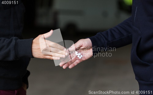 Image of close up of addict buying dose from drug dealer