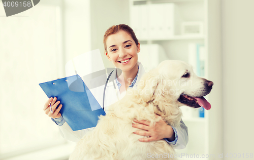 Image of happy doctor with retriever dog at vet clinic