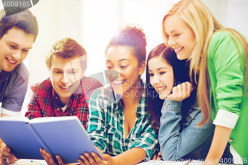 Image of students reading book at school