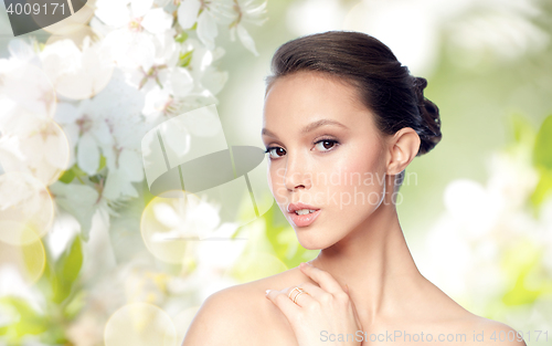 Image of face of beautiful asian woman with golden ring