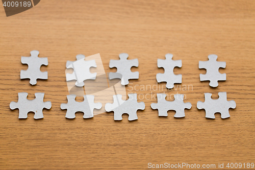 Image of close up of puzzle pieces on wooden surface