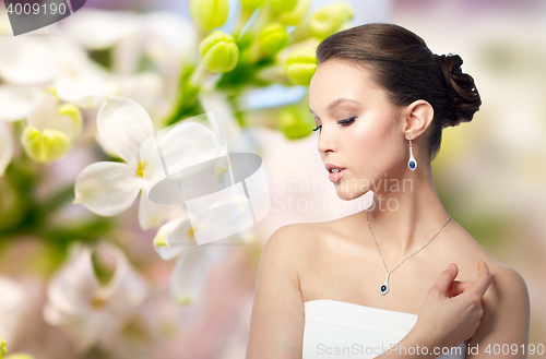 Image of beautiful asian woman with earring and pendant