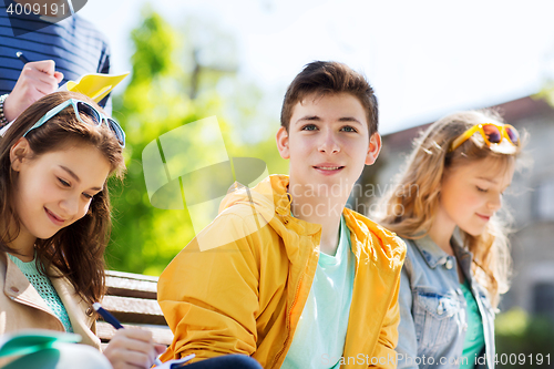 Image of group of students with notebooks at school yard