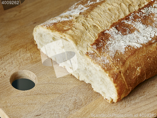 Image of piece of white cereal bread on wood board