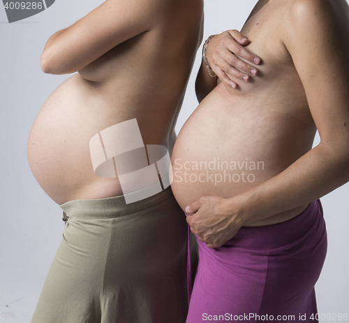 Image of Pregnant Women holding her hands on beautiful belly