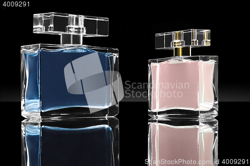 Image of blue and pink elegant perfume bottles in black background