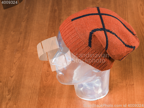 Image of orange woolen handmade cap basketball ball alike