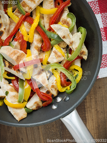 Image of delicious wrap tortilla with spicy chicken vegetables guacamole