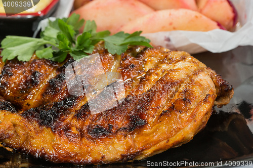 Image of plate of grilled meat with fries