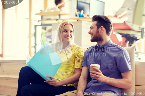 Image of office workers with folder and coffee