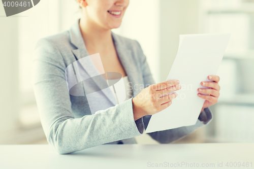 Image of close up of woman reading papers or tax report