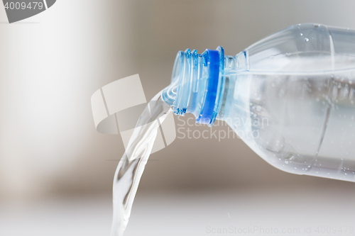 Image of close up of water pouring from plastic bottle