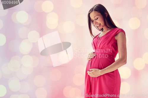Image of happy pregnant woman with big tummy