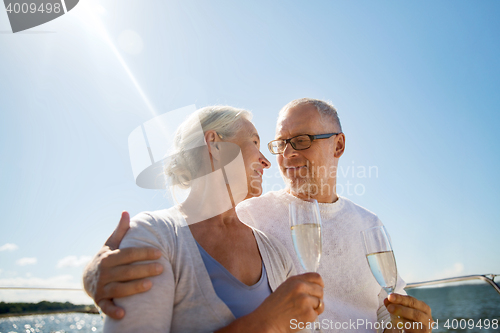 Image of senior couple drinking champagne on sail boat