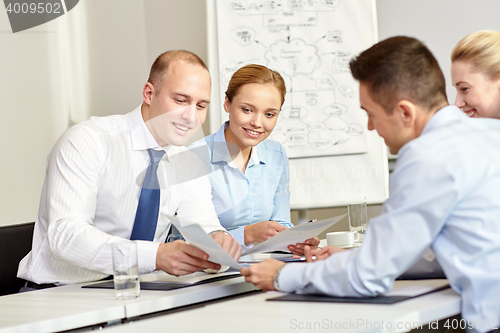 Image of business people with papers meeting in office