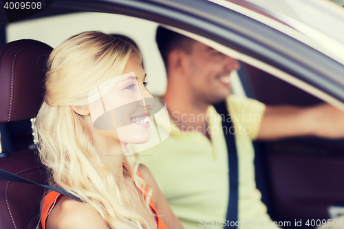 Image of happy man and woman driving car