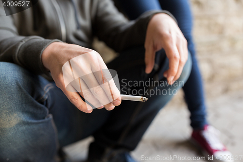 Image of close up of young man smoking cigarette