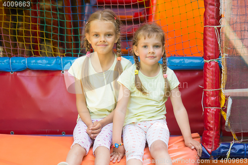 Image of Two girls sit on a soft exit from the game room