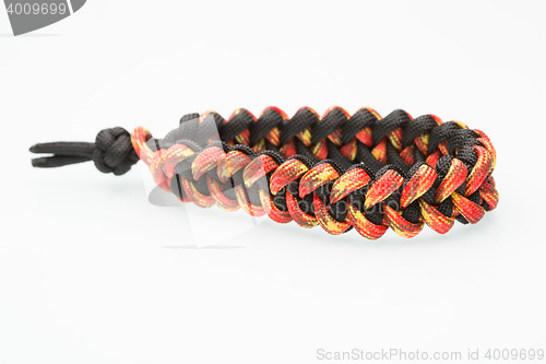Image of black and orange braided bracelet on white background