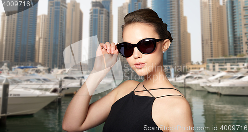 Image of beautiful young woman in elegant black sunglasses