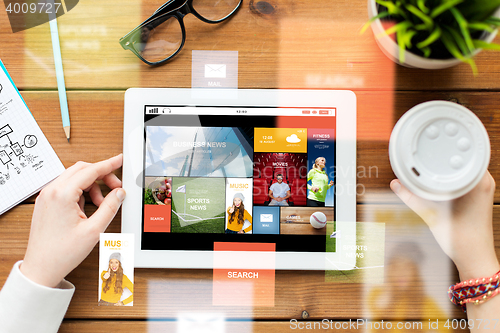 Image of close up of woman with tablet pc on wooden table