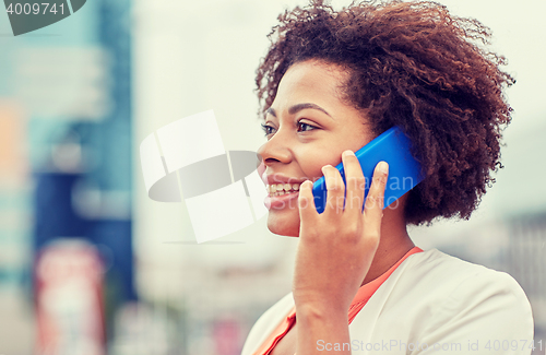 Image of happy young african american businesswoman in city