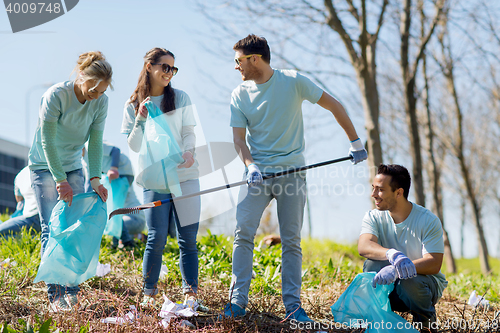 Image of volunteers with garbage bags cleaning park area