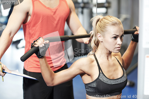 Image of man and woman flexing muscles on gym machine