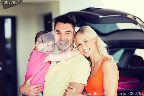 Image of happy family with hatchback car at home parking