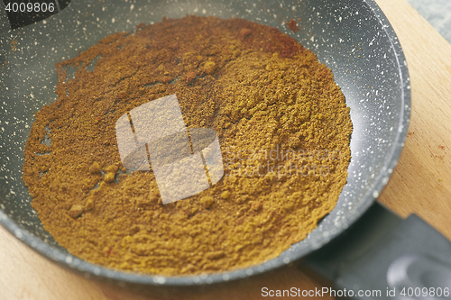 Image of different spices paprika curry garam massala in pan