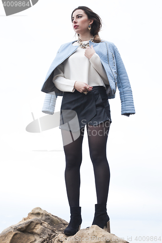 Image of fashionable young model posing with trendy clothes