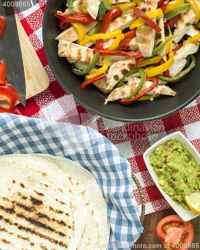 Image of delicious wrap tortilla with spicy chicken vegetables guacamole