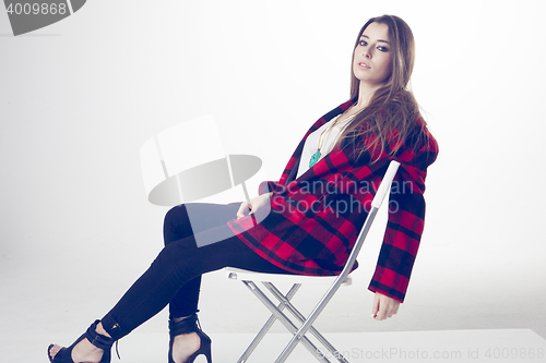 Image of fashionable young model posing with trendy clothes